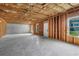 Spacious unfinished basement with concrete walls, ready for customization and featuring bright window at 3259 Ivy Crossing Dr, Buford, GA 30519