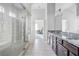 Modern bathroom featuring double vanities, granite countertops, a walk in glass shower, and gray tile at 3259 Ivy Crossing Dr, Buford, GA 30519