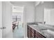 Bathroom vanity featuring double sinks, granite countertops, and views into the adjoining dining area at 3259 Ivy Crossing Dr, Buford, GA 30519