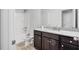 Bathroom featuring a granite countertop vanity, dark cabinets, and a shower at 3259 Ivy Crossing Dr, Buford, GA 30519