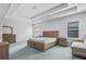 Spacious bedroom with tray ceilings, carpet flooring, and natural light from the two windows at 3259 Ivy Crossing Dr, Buford, GA 30519