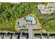 Aerial view of community pool with chairs, umbrella, and a clubhouse surrounded by mature trees at 3259 Ivy Crossing Dr, Buford, GA 30519