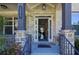 Inviting entryway featuring a stylish front door, brick columns, and address number for a warm welcome at 3259 Ivy Crossing Dr, Buford, GA 30519