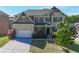 Charming two-story brick home featuring an attached two-car garage and manicured landscaping in a Gathering-friendly neighborhood at 3259 Ivy Crossing Dr, Buford, GA 30519