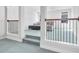 Hallway featuring carpet flooring, iron handrails, and a seating area with sofa and coffee table at 3259 Ivy Crossing Dr, Buford, GA 30519
