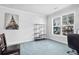 Bright and airy office space with neutral paint, shelving, and a large window overlooking the greenery at 3259 Ivy Crossing Dr, Buford, GA 30519