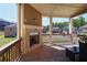 Covered deck featuring a cozy brick fireplace, perfect for outdoor entertainment and relaxation at 3259 Ivy Crossing Dr, Buford, GA 30519