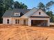 New construction home with white siding, black roof, and open garage at 610 Presley Farm Pkwy, Rockmart, GA 30153