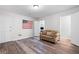 Finished basement with hardwood floors, sofa, and a door to office at 1223 Whitlock Ridge Sw Dr, Marietta, GA 30064