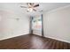 A well-lit bedroom with neutral paint, dark hardwood floors, and a large window at 1223 Whitlock Ridge Sw Dr, Marietta, GA 30064