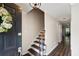 Bright foyer with hardwood floors, staircase and black front door at 1223 Whitlock Ridge Sw Dr, Marietta, GA 30064