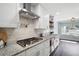 Bright kitchen featuring granite countertops, stainless steel pot filler, and custom cabinets at 1223 Whitlock Ridge Sw Dr, Marietta, GA 30064