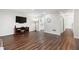 Spacious living room with hardwood floors, large TV, and ample natural light at 1223 Whitlock Ridge Sw Dr, Marietta, GA 30064