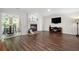 Open living room featuring hardwood floors, brick fireplace, and adjacent dining area at 1223 Whitlock Ridge Sw Dr, Marietta, GA 30064