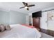 Main bedroom with hardwood floors, TV, and adjoining bathroom with sliding barn door at 1223 Whitlock Ridge Sw Dr, Marietta, GA 30064