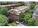 Aerial view of complex surrounded by mature trees in a garden setting at 273 12Th Ne St # 114, Atlanta, GA 30309