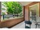 Charming brick balcony with a serene outdoor view of lush greenery and trees at 273 12Th Ne St # 114, Atlanta, GA 30309
