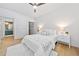 Bright bedroom with wood floors, ceiling fan, and ensuite bathroom access at 273 12Th Ne St # 114, Atlanta, GA 30309