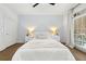 Simple bedroom with a door to the left and a large window with blinds on the right at 273 12Th Ne St # 114, Atlanta, GA 30309