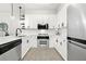 Modern kitchen with white cabinetry, stainless steel appliances, and sleek countertops at 273 12Th Ne St # 114, Atlanta, GA 30309