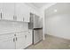 Modern kitchen showcasing stainless steel refrigerator and sleek, white cabinetry at 273 12Th Ne St # 114, Atlanta, GA 30309
