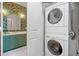 Convenient laundry area with stacked washer and dryer, adjacent to the stylish bathroom at 273 12Th Ne St # 114, Atlanta, GA 30309