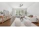 Open living space with hardwood floors, white walls, and comfortable seating at 273 12Th Ne St # 114, Atlanta, GA 30309