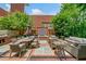 Outdoor patio with an in-built grill, fountain, dining, and seating area, perfect for outdoor entertaining at 273 12Th Ne St # 114, Atlanta, GA 30309