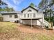 Backyard with wooden deck, white railing, staircase, and ample room for outdoor entertaining and relaxation at 339 Warrenton Dr, Douglasville, GA 30134