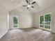 Bright bedroom featuring a ceiling fan, natural light from two windows, and neutral carpet at 339 Warrenton Dr, Douglasville, GA 30134