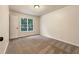 Bright bedroom with a window providing natural light and neutral carpet at 339 Warrenton Dr, Douglasville, GA 30134