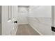Walk-in closet featuring shelving and neutral carpet at 339 Warrenton Dr, Douglasville, GA 30134