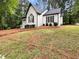 Home exterior boasts a manicured front lawn, well-trimmed bushes, and dark trim for a welcoming and elegant curb appeal at 339 Warrenton Dr, Douglasville, GA 30134