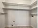 Spacious laundry room equipped with shelving for convenient storage at 339 Warrenton Dr, Douglasville, GA 30134
