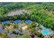 Aerial view featuring community amenities: tennis courts, lake access, pool, and playgrounds at 3565 Hickory Branch Trl, Suwanee, GA 30024