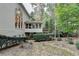 Back exterior featuring a sunroom, wooden deck, and privacy landscaping at 3565 Hickory Branch Trl, Suwanee, GA 30024