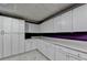 Basement with white cabinets and a countertop at 3565 Hickory Branch Trl, Suwanee, GA 30024