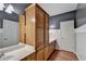 Dual sink bathroom with light-toned cabinets and a large mirror at 3565 Hickory Branch Trl, Suwanee, GA 30024