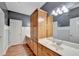 Bathroom with wood-look floors, wood cabinets, and a large counter space at 3565 Hickory Branch Trl, Suwanee, GA 30024