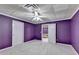 Bedroom with neutral carpet and walls painted in a vibrant purple hue at 3565 Hickory Branch Trl, Suwanee, GA 30024
