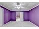 Bedroom with neutral carpet and walls painted in a vibrant purple hue at 3565 Hickory Branch Trl, Suwanee, GA 30024