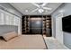 Charming bedroom features neutral walls, soft carpet, and dark built-in shelving at 3565 Hickory Branch Trl, Suwanee, GA 30024