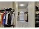 Walk-in closet with carpeted floors, shelving, and clothing racks with window at 3565 Hickory Branch Trl, Suwanee, GA 30024