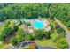 Aerial view of the community pool complex, featuring multiple pools, a slide, and ample seating at 3565 Hickory Branch Trl, Suwanee, GA 30024
