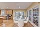 Dining area with hardwood floors, large windows, connected to kitchen with breakfast bar at 3565 Hickory Branch Trl, Suwanee, GA 30024