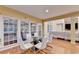Dining area with hardwood floors, large windows, with view into connected living space at 3565 Hickory Branch Trl, Suwanee, GA 30024