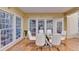 Dining area with hardwood floors, large windows, and a modern glass table set at 3565 Hickory Branch Trl, Suwanee, GA 30024