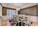 Formal dining room with a modern chandelier and natural light, great for entertaining at 3565 Hickory Branch Trl, Suwanee, GA 30024
