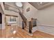 Spacious foyer with hardwood floors, staircase with oak banister, and view of the living room at 3565 Hickory Branch Trl, Suwanee, GA 30024
