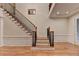 Bright foyer with hardwood floors and staircase with oak banister and black iron balusters at 3565 Hickory Branch Trl, Suwanee, GA 30024